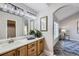 Bright bathroom featuring a modern vanity with ample storage and decorative accents at 6845 S Webster St # G, Littleton, CO 80128