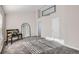 Well-lit bedroom featuring neutral tones, arched mirror and carpeting at 6845 S Webster St # G, Littleton, CO 80128