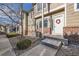 Inviting townhome entrance with brick accents, concrete steps and walkway, and a festive wreath at 6845 S Webster St # G, Littleton, CO 80128