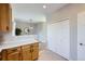 Modern kitchen with wooden cabinets and quartz countertop looking into the adjacent living room at 6845 S Webster St # G, Littleton, CO 80128