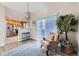 Cozy living area with a stylish chair, modern lighting, and a view into the adjacent kitchen at 6845 S Webster St # G, Littleton, CO 80128