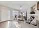 Sunlit living room with hardwood floors, fireplace, and large window creating a welcoming space at 6845 S Webster St # G, Littleton, CO 80128