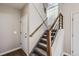 Carpeted staircase with a modern handrail design and a large window for natural light at 6845 S Webster St # G, Littleton, CO 80128