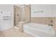 Bright bathroom featuring a soaking tub with tile surround and glass enclosed shower at 1194 Red Lodge Dr # 201, Evergreen, CO 80439