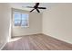 Bright bedroom with hardwood floors, a ceiling fan, and a large window offering natural light at 1194 Red Lodge Dr # 201, Evergreen, CO 80439