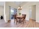 Cozy dining room features a wood table set and a sliding glass door to an outdoor balcony view at 1194 Red Lodge Dr # 201, Evergreen, CO 80439