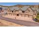 Exterior view showcasing townhome architecture with multiple garages and balconies in a picturesque location at 1194 Red Lodge Dr # 201, Evergreen, CO 80439
