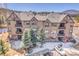 Three-story townhouse featuring private balconies, decorative trim, and beautiful green surroundings at 1194 Red Lodge Dr # 201, Evergreen, CO 80439
