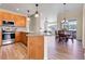 Open-concept kitchen featuring wood cabinets, stainless steel appliances, and modern flooring at 1194 Red Lodge Dr # 201, Evergreen, CO 80439