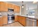 A modern kitchen with stainless steel appliances and a stone backsplash at 1194 Red Lodge Dr # 201, Evergreen, CO 80439
