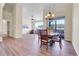 An open-concept living room features wood floors and a dining area with scenic views at 1194 Red Lodge Dr # 201, Evergreen, CO 80439