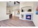Spacious living room with a fireplace and an open view to the kitchen and dining area at 1194 Red Lodge Dr # 201, Evergreen, CO 80439
