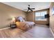 Comfortable main bedroom features a ceiling fan, a side table with lamp, and a window view at 1194 Red Lodge Dr # 201, Evergreen, CO 80439