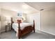 Bedroom features a bed with a decorative headboard, bedside tables, and closet space at 2939 S Zurich Ct, Denver, CO 80236