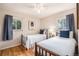 Comfortable bedroom featuring hardwood floors, twin beds, and bright windows, perfect for relaxation at 2939 S Zurich Ct, Denver, CO 80236