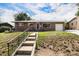 Charming single-story brick home featuring an attached garage and a well-manicured front yard with stairs at 2939 S Zurich Ct, Denver, CO 80236