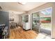 Bright kitchen flowing into a dining space, featuring stainless steel appliances and access to the backyard at 2939 S Zurich Ct, Denver, CO 80236
