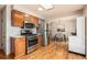 Functional kitchen with wood cabinets, stainless appliances, and an open layout to the dining area at 2939 S Zurich Ct, Denver, CO 80236