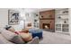 Comfortable living room boasts a brick fireplace with built-in shelving and cozy seating arrangements at 2939 S Zurich Ct, Denver, CO 80236