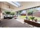 Covered patio provides outdoor living space with ample seating and a view of the backyard at 2939 S Zurich Ct, Denver, CO 80236