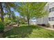 Expansive backyard with mature trees, lush lawn, and cozy gazebo at 5302 S Robb Ct, Littleton, CO 80127