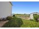 View of backyard with garden, shed, and lawn at 5302 S Robb Ct, Littleton, CO 80127
