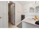 Bathroom featuring vanity with single sink, modern fixtures, a mirror and a door at 5302 S Robb Ct, Littleton, CO 80127
