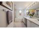 Bright bathroom featuring a double sink vanity, a soaking tub and a separate shower at 5302 S Robb Ct, Littleton, CO 80127