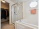 A view of a bright and tidy bathroom with a shower and soaking tub combo at 5302 S Robb Ct, Littleton, CO 80127