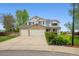 Charming two-story home featuring a three-car garage, well-maintained lawn, and beautiful landscaping at 5302 S Robb Ct, Littleton, CO 80127