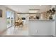 Bright kitchen featuring white cabinets, an eat-in table, and sliding doors leading to a deck at 5302 S Robb Ct, Littleton, CO 80127
