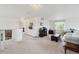 Bright upstairs landing living room with white couch, ottoman and carpet at 5302 S Robb Ct, Littleton, CO 80127