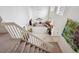 Vaulted ceilings in this living room featuring large bright windows and beautiful staircase at 5302 S Robb Ct, Littleton, CO 80127