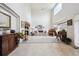 Large living room with high ceilings, natural light and a floral sofa at 5302 S Robb Ct, Littleton, CO 80127