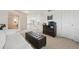 Upstairs landing living room featuring sofa, ottoman, drawers and doors at 5302 S Robb Ct, Littleton, CO 80127