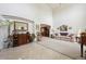 Bright living room with high ceilings, tile flooring, and a view into another room at 5302 S Robb Ct, Littleton, CO 80127