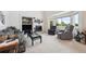 Cozy living room featuring a fireplace, built-in shelves, and comfortable seating near a large window at 5302 S Robb Ct, Littleton, CO 80127