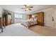 Spacious main bedroom features a large bed, built in storage, and large windows at 5302 S Robb Ct, Littleton, CO 80127