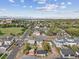 Aerial view of neighborhood, with tree-lined streets, and the city beyond at 2010 Irving St, Denver, CO 80211