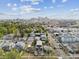 An aerial view showcases a neighborhood with a mix of modern and traditional homes against a city skyline backdrop at 2010 Irving St, Denver, CO 80211