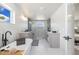 Modern primary bathroom featuring a glass enclosed shower, soaking tub, and dual vanities at 2010 Irving St, Denver, CO 80211