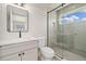 Clean bathroom featuring a glass enclosed shower, vanity and toilet at 2010 Irving St, Denver, CO 80211