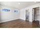 Well-lit bedroom with hardwood floors, featuring an attached bathroom and closet at 2010 Irving St, Denver, CO 80211
