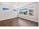 Bright bedroom with hardwood floors and multiple windows offering natural light and neighborhood views at 2010 Irving St, Denver, CO 80211