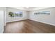 Bright bedroom featuring hardwood floors, white walls, and large windows with neighborhood views at 2010 Irving St, Denver, CO 80211