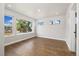 Bright bedroom featuring hardwood floors, white walls, and large windows at 2010 Irving St, Denver, CO 80211