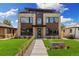 Contemporary home boasts a manicured lawn, stylish stone facade, and a unique rooftop terrace at 2010 Irving St, Denver, CO 80211