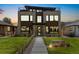 Stunning modern home with stone and wood accents, well-manicured lawn, and sleek rooftop deck at 2010 Irving St, Denver, CO 80211