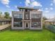 Modern home featuring stone accents, large windows, and a well-manicured lawn, offering contemporary charm at 2010 Irving St, Denver, CO 80211
