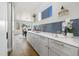 Bright kitchen featuring white countertops, grey cabinets, stylish backsplash, and stainless steel appliances at 2010 Irving St, Denver, CO 80211